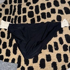 Black bathing suit bottoms with white lace sides